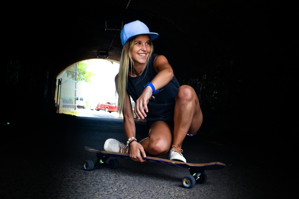 Teenager smiles and does low key maneuver on a skateboard in a tunnel. Cannabis use affects teen brain development. Earthy Now