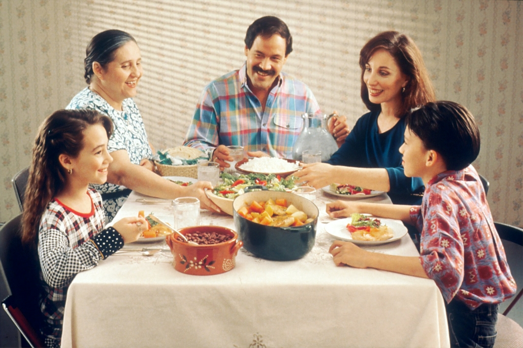 Three generation family discusses cannabis at dinner table. Sparking Healthy Conversations About Cannabis at Home